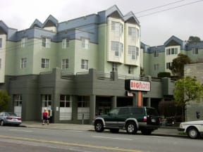 a car parked in front of an apartment building