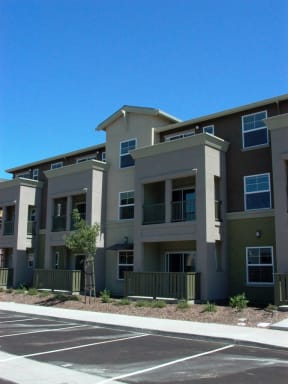 an apartment building with a street in front of it