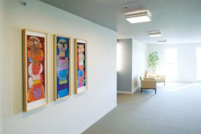 a group of paintings on a wall in a room