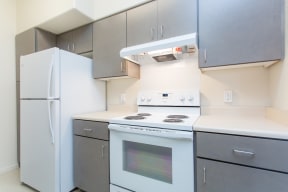 a kitchen with white appliances and stainless steel cabinets and a refrigerator