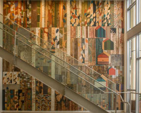 the stairwell in the lobby of the museum of modern art with a colorful wall