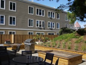 a patio with tables and chairs in front of a building