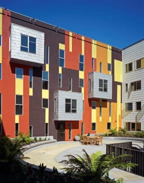 a colorful building with a courtyard in front of it