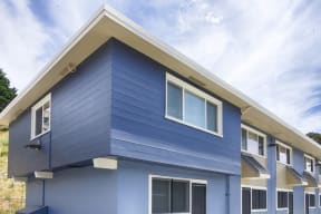 a blue house with blue siding and white windows