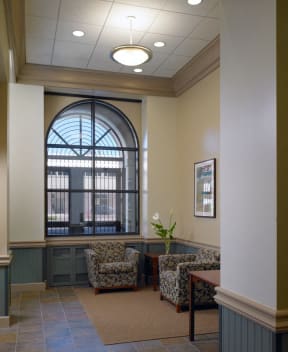 a lobby with chairs and a large window