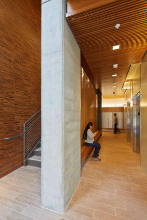 a person sitting on a bench in a hallway