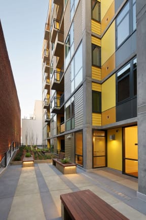 a courtyard in front of a tall building