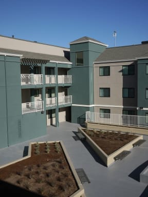 a view of the courtyard of an apartment building