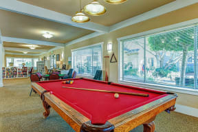 a game room with a red pool table