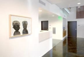 a painting of two heads on a wall in a room