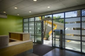 a view of a lobby with glass doors and a staircase