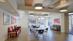 a large room with tables and chairs and a large window