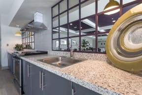 a kitchen with granite counter tops and a stainless steel sink