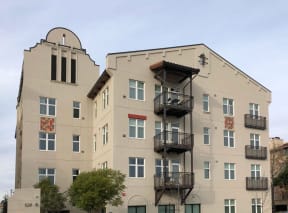 a large building with many balconies and a blue sky