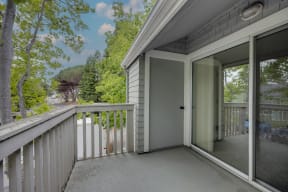 the view from the balcony of a home with a sliding glass door