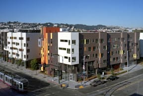 an aerial view of an apartment building on a city street