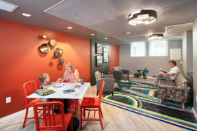 a family sitting at a table in a living room