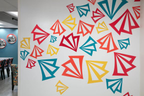 a wall with different colored triangles drawn on it