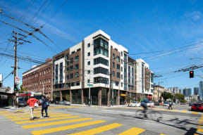 people crossing a city street in front of a building