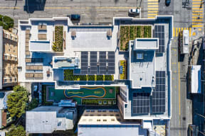 an aerial view of a building with green plants on its roof