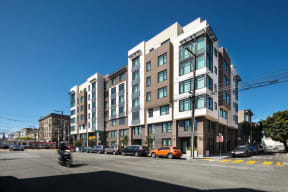a street view of a large apartment building on a city street