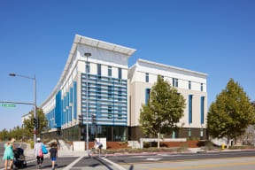 a large building with people walking in front of it