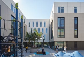 a rendering of a building with people playing in a courtyard
