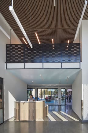a large lobby with a reception desk and a large window