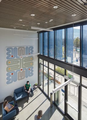 a man sitting on a couch in the lobby of a building
