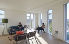a living room filled with furniture and a large window
