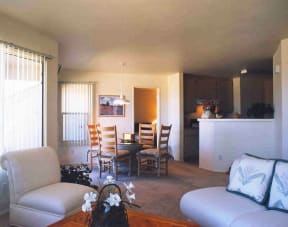 an open living room and dining room with a table and chairs