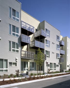 a row of apartment buildings with balconies and a street