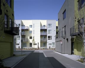 an empty street in front of some apartment buildings