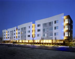 a large white building with a street in front of it