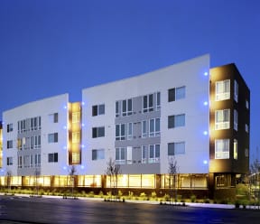 a large white building with a street in front of it