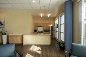 a kitchen with a sink and a refrigerator in a room