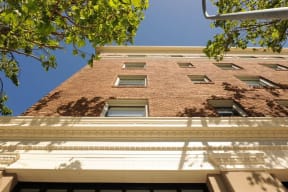 a tall brick building with windows and a street light