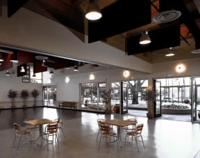 a large room with tables and chairs in therium of a building