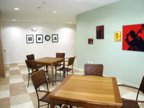 a dining room with tables and chairs and artwork on the wall