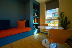 a living room with a couch and a table and a window