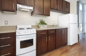 a kitchen with white appliances and wooden cabinets