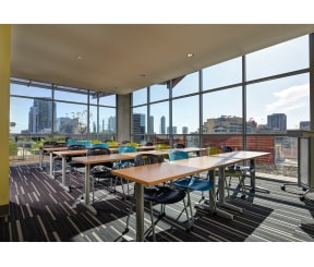 a room with tables and chairs and a view of a city