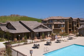 an aerial view of an apartment complex with a swimming pool
