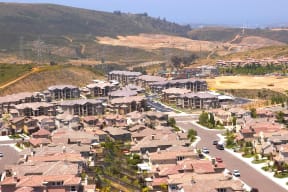 an aerial view of a suburb of a city with mountains in the background