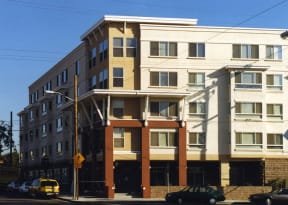 an apartment building on the corner of a city street