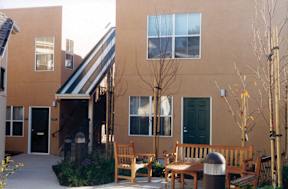 the outside of a building with a patio and benches