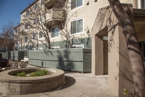 a large concrete planter in front of an apartment building