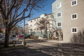 the view of an apartment building from the street