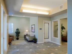 a lobby with a couch and a chair and a door