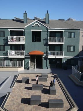 people standing in front of an apartment building